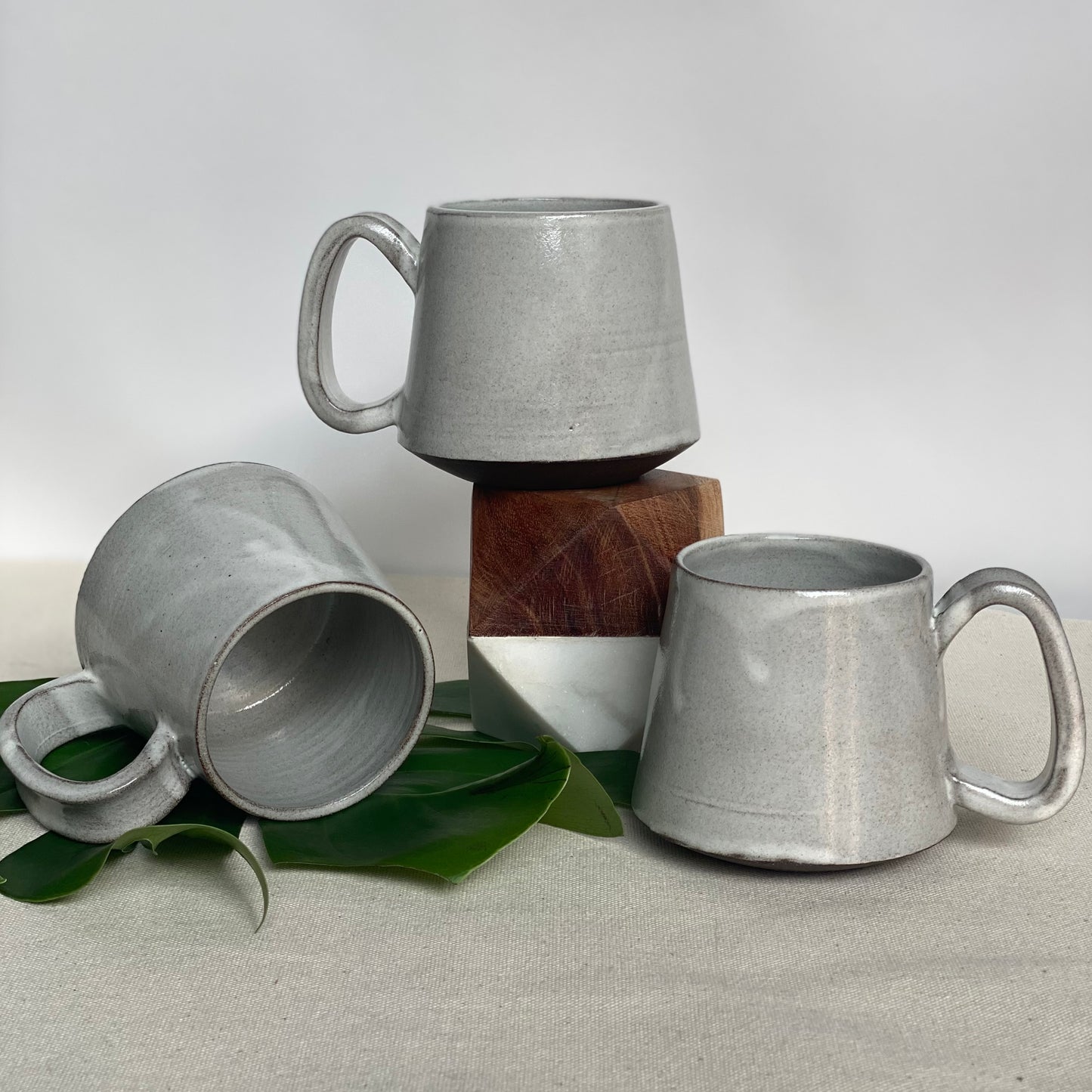 Small Dark Brown Mugs in Waxy White Glaze