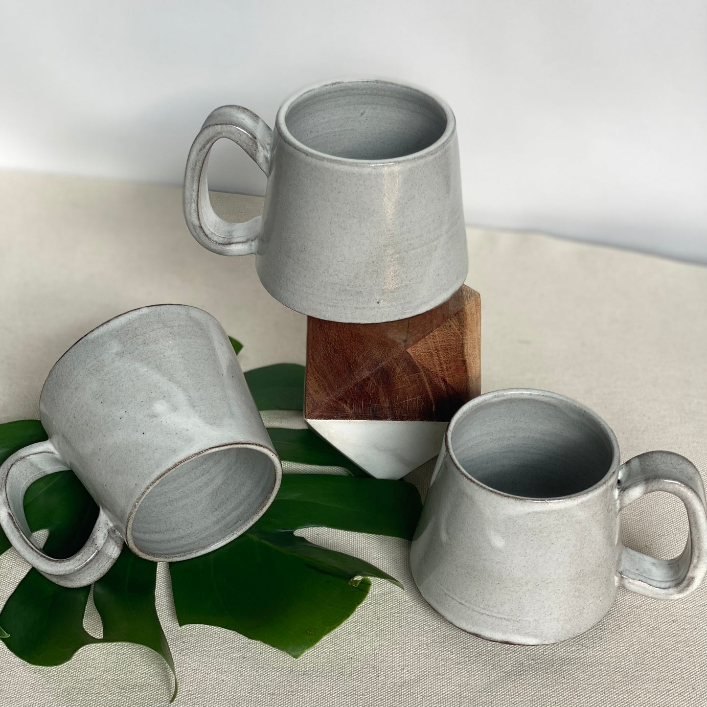Small Dark Brown Mugs in Waxy White Glaze